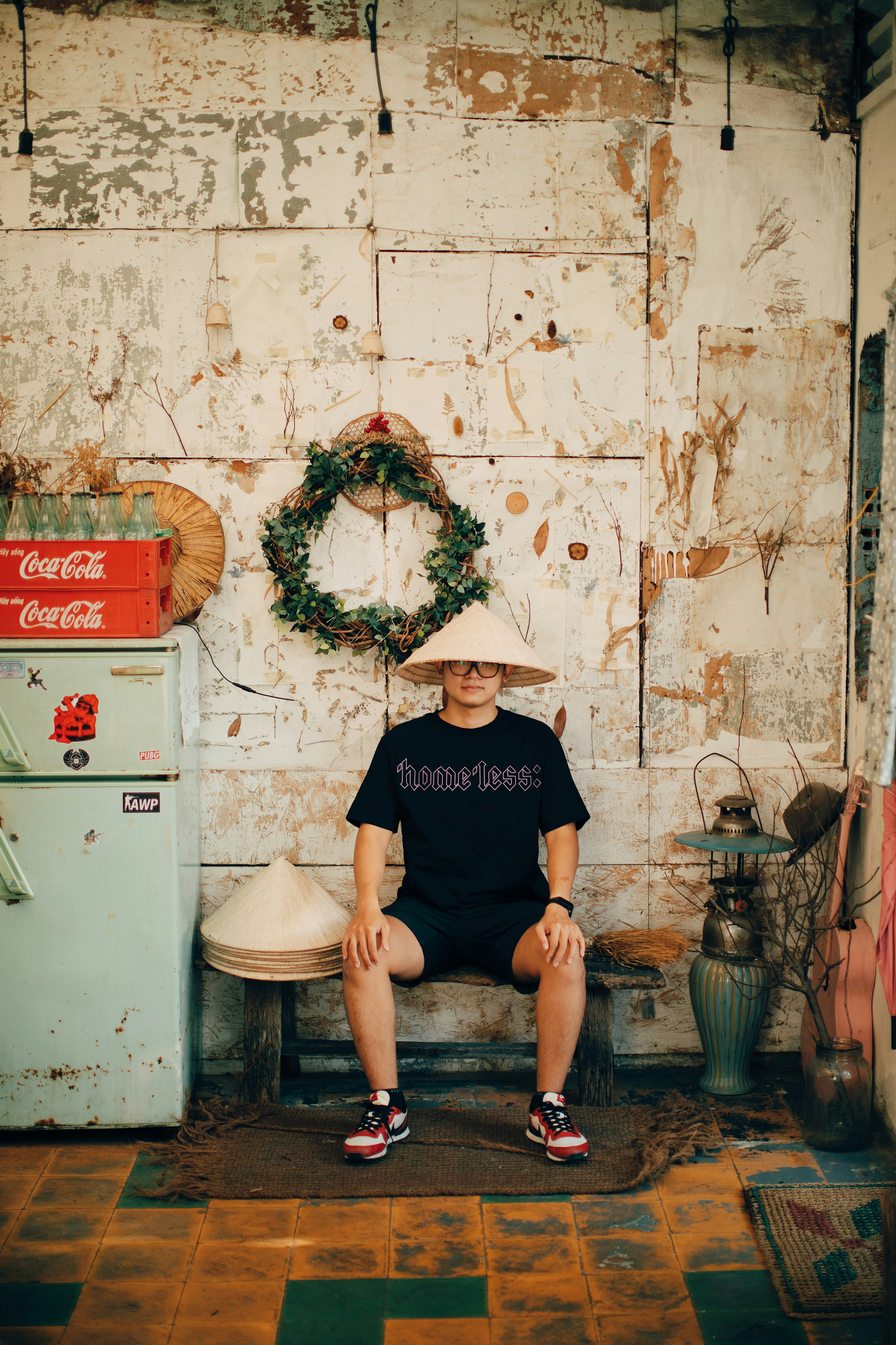 man in black crew neck t-shirt and black shorts sitting on black metal seat